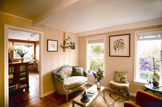 The view from the front door through the living room and into the dining room showcases the oak parquet floor, which dates back to the 1920s. Alma had multiple layers of flooring removed to reveal the original fir floor in the kitchen.